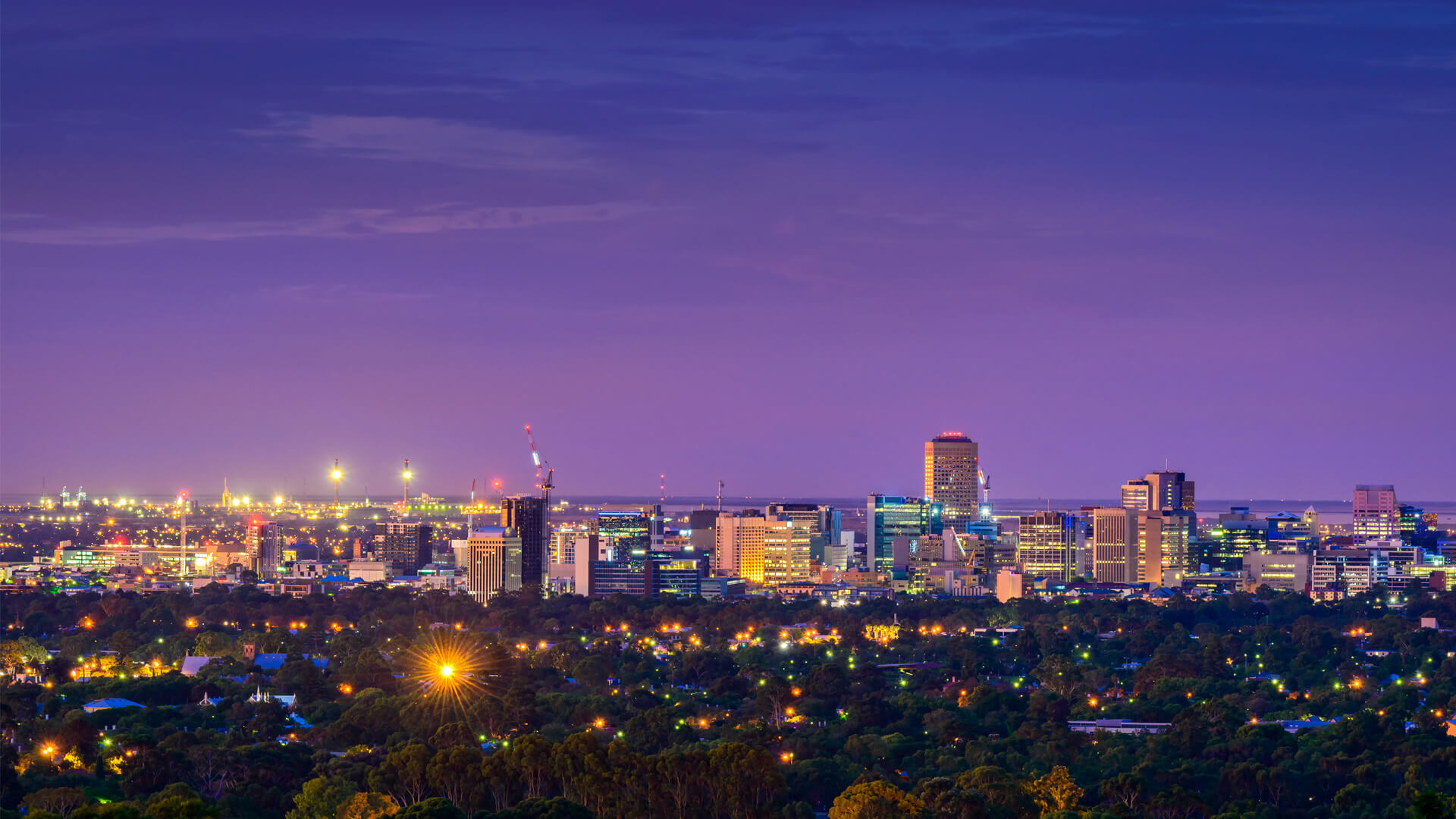 The Adelaide skyline at dusk, looking across the city from the eastern hills